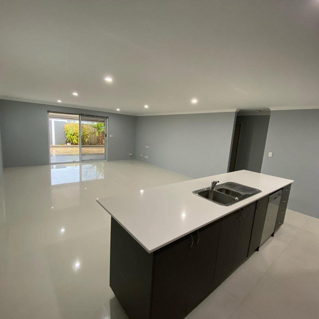 Modern kitchen with glossy flooring and island counter.